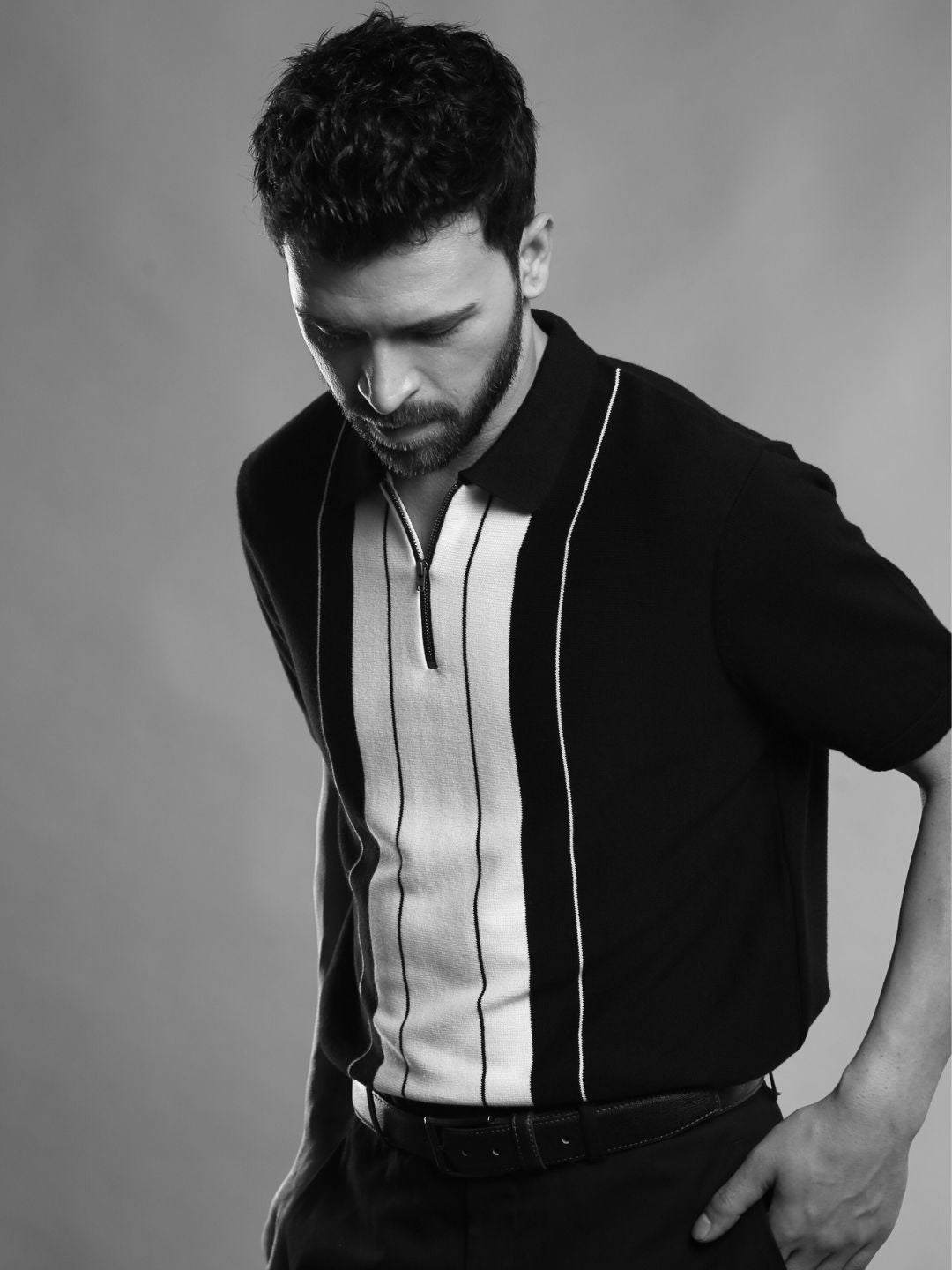 Man wearing black and white vertical striped polo t-shirt